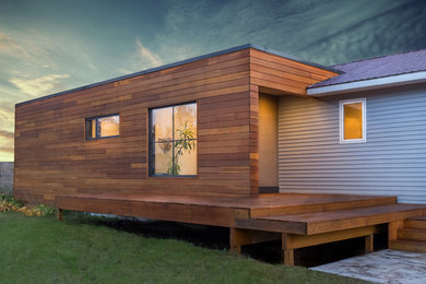 Стильный дизайн: маленький, одноэтажный, деревянный, синий частный загородный дом в стиле модернизм с плоской крышей для на участке и в саду - последний тренд