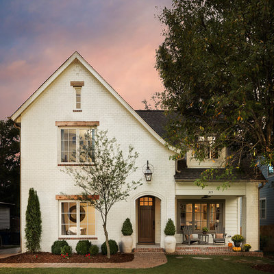Mid-sized elegant white two-story brick exterior home photo in Birmingham