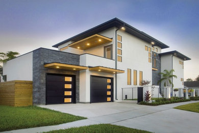 Foto de fachada de casa beige moderna grande de dos plantas con revestimientos combinados, tejado plano y tejado de metal