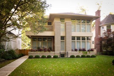 Large transitional gray three-story brick exterior home photo in Chicago with a hip roof
