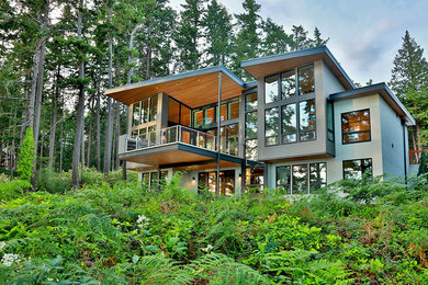 Inspiration for a large modern multicolored two-story mixed siding house exterior remodel in Seattle with a shed roof and a metal roof