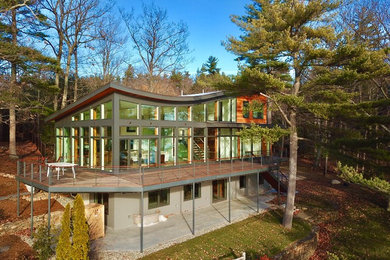 Ejemplo de fachada de casa minimalista de tamaño medio de tres plantas con revestimientos combinados y tejado plano