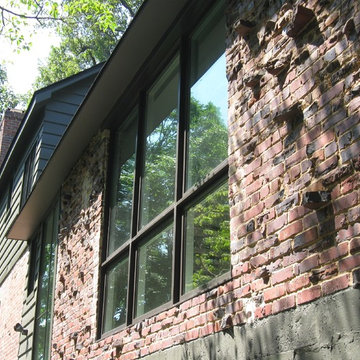 Modern window cut into existing brick wall.