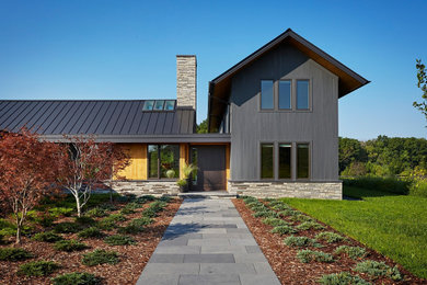 Example of a large minimalist black two-story exterior home design in Milwaukee