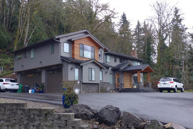 Inspiration for a large contemporary brown two-story mixed siding exterior home remodel in Seattle with a shingle roof