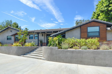 Example of a mid-century modern gray one-story mixed siding exterior home design in Orange County with a shingle roof
