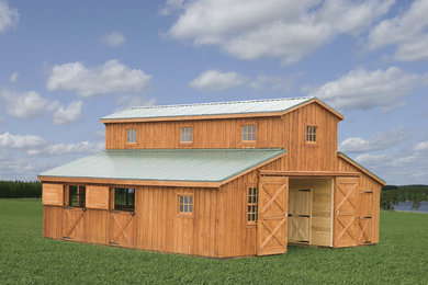 На фото: большой, двухэтажный, деревянный, коричневый барнхаус (амбары) дом в стиле кантри с двускатной крышей и металлической крышей с