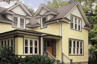 Mid-sized elegant yellow two-story vinyl exterior home photo in Philadelphia