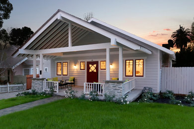 Ejemplo de fachada de casa gris de estilo americano de tamaño medio de una planta con tejado a dos aguas y tejado de teja de madera