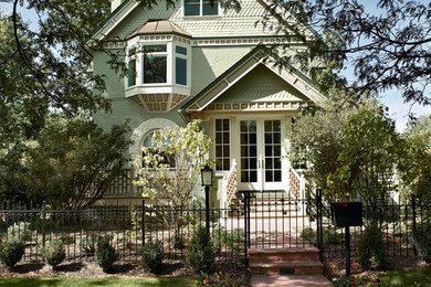 Inspiration for a green victorian two floor house exterior in Denver.