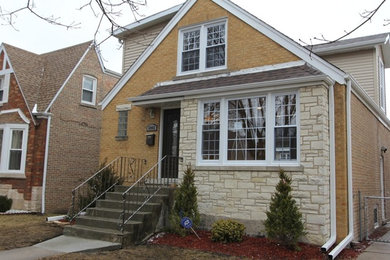 Inspiration for a mid-sized transitional two-story brick gable roof remodel in Chicago