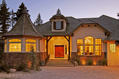 Inspiration for a large transitional beige one-story mixed siding exterior home remodel in Other with a shingle roof