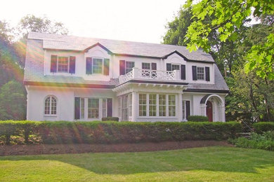 Inspiration for a large transitional white two-story stucco exterior home remodel in Boston with a gambrel roof