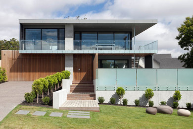 Modelo de fachada de casa multicolor contemporánea grande de dos plantas con tejado plano