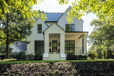 Example of a large trendy white two-story brick house exterior design in Atlanta