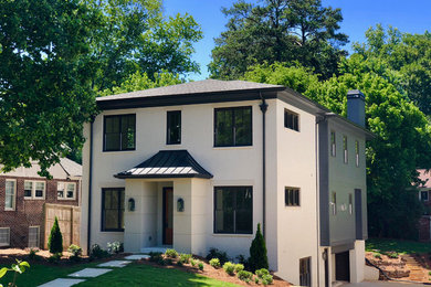 Example of a mid-sized transitional white three-story brick house exterior design in Atlanta with a hip roof and a mixed material roof