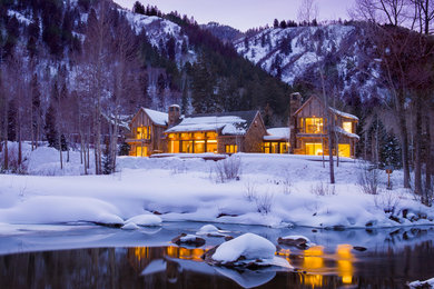 Example of an arts and crafts two-story wood exterior home design in Denver