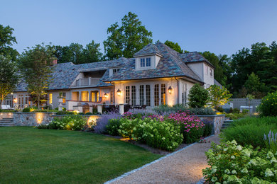 Example of a large classic exterior home design in New York with a clipped gable roof