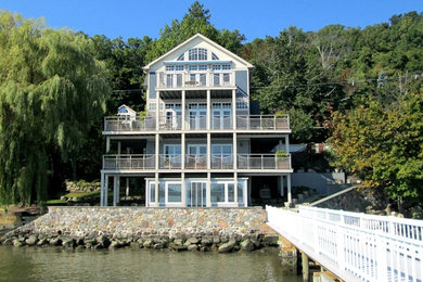 Ejemplo de fachada de casa azul costera extra grande de tres plantas