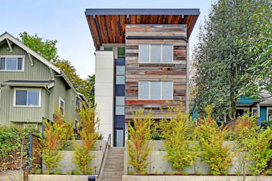 Inspiration for a large contemporary multicolored three-story mixed siding exterior home remodel in Seattle with a shed roof