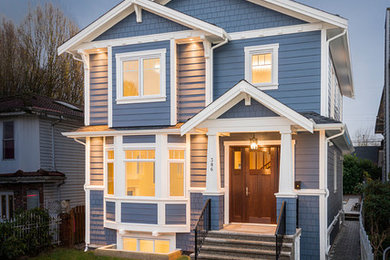 Mid-sized elegant blue two-story concrete fiberboard gable roof photo in Vancouver