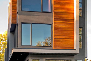 Mid-sized modern gray three-story wood flat roof idea in Calgary