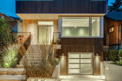 Contemporary brown two-story wood house exterior idea in Vancouver