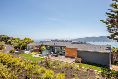Inspiration for a large contemporary gray two-story wood exterior home remodel in San Francisco with a shingle roof