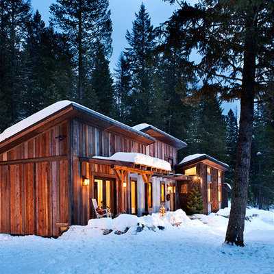 Inspiration for a mid-sized rustic brown one-story wood house exterior remodel in Other with a shed roof and a shingle roof