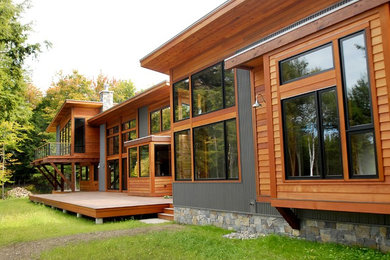 Huge contemporary three-story mixed siding exterior home idea in Burlington