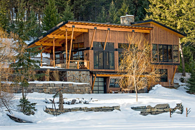 Mountain style two-story wood exterior home photo in Other with a shed roof