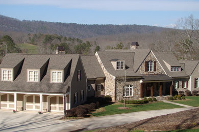 Huge elegant beige two-story mixed siding house exterior photo in Atlanta with a mixed material roof