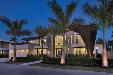 Example of a huge minimalist white two-story house exterior design in Miami