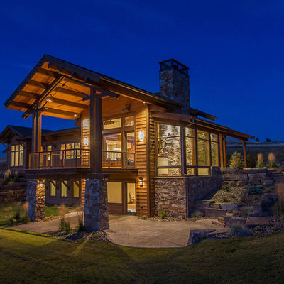 Inspiration for a large rustic brown two-story mixed siding gable roof remodel in Other