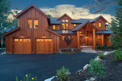 Large mountain style brown two-story wood exterior home photo in Denver