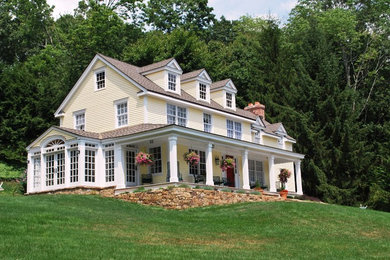 Example of a classic yellow exterior home design in New York