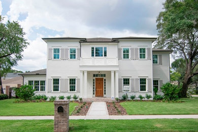 Example of a mid-sized classic white two-story wood house exterior design in Tampa with a shingle roof
