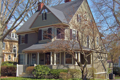 Example of an ornate green wood exterior home design in Boston