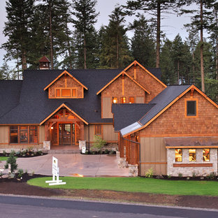 Inspiration for a large rustic brown three-story wood exterior home remodel in Seattle