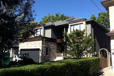 Inspiration for a mid-sized transitional gray two-story stone exterior home remodel in Toronto