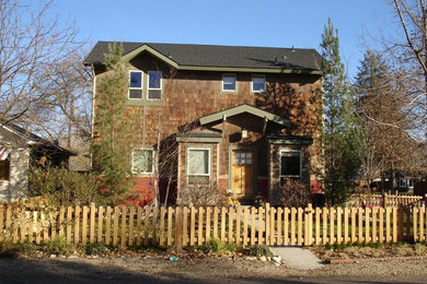 Inspiration for a brown two floor house exterior in Boise with wood cladding.