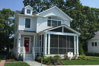 Example of a small classic white two-story vinyl exterior home design in Other with a shingle roof