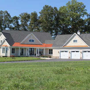 Example of a mid-sized farmhouse beige one-story stucco exterior home design in Other with a mixed material roof