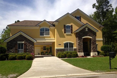 Example of a yellow two-story exterior home design in Jacksonville