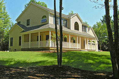 Example of a mid-sized transitional beige two-story concrete fiberboard exterior home design in Burlington