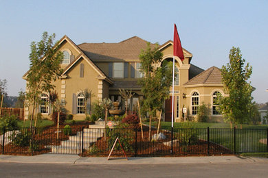 Design ideas for a large and beige traditional two floor render house exterior in Sacramento.