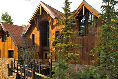 Example of a large mountain style brown two-story wood exterior home design in Denver