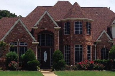 Inspiration for a large and red brick house exterior in Dallas with three floors and a pitched roof.