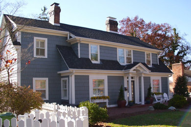 Example of a mid-sized blue two-story vinyl exterior home design in Other