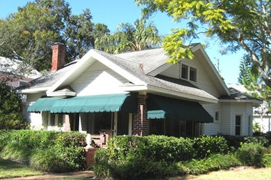 Example of a mid-sized classic white two-story mixed siding gable roof design in Tampa